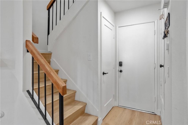 entrance foyer with wood finished floors and stairway