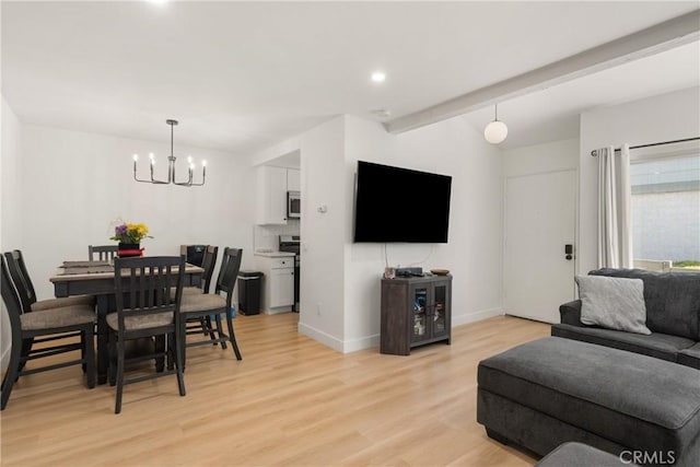 living room with recessed lighting, baseboards, an inviting chandelier, and light wood-type flooring