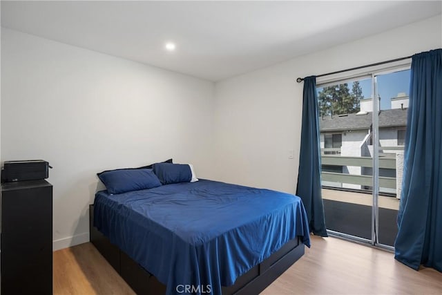bedroom featuring recessed lighting, wood finished floors, baseboards, and access to outside