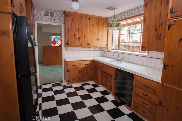 kitchen featuring a sink, backsplash, light floors, tile countertops, and black appliances