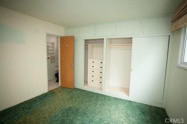 unfurnished bedroom with carpet floors and a closet