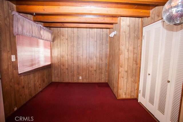basement featuring wooden walls and carpet flooring
