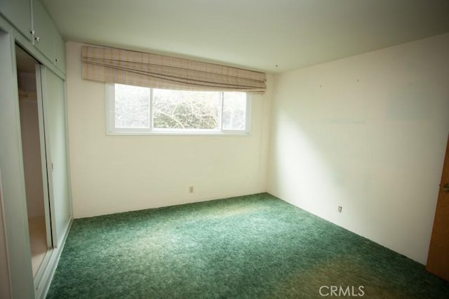 unfurnished bedroom with carpet and a closet