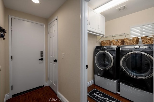 33077 Monte Dr, Temecula, CA 92592 - laundry area featuring visible vents, baseboards, dark wood-style floors, cabinet space, and independent washer and dryer