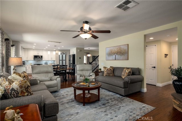 33077 Monte Dr, Temecula, CA 92592 - living area with ceiling fan, dark wood finished floors, recessed lighting, visible vents, and stairway