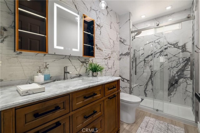 33077 Monte Dr, Temecula, CA 92592 - bathroom with vanity, a marble finish shower, wood finished floors, and tile walls