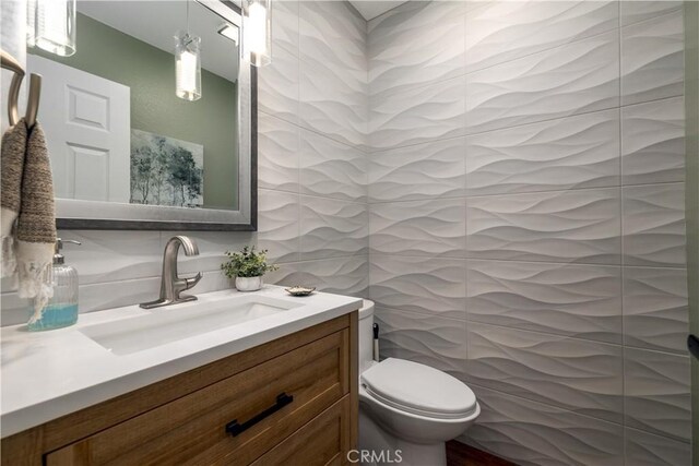 33077 Monte Dr, Temecula, CA 92592 - bathroom with toilet, tile walls, decorative backsplash, and vanity