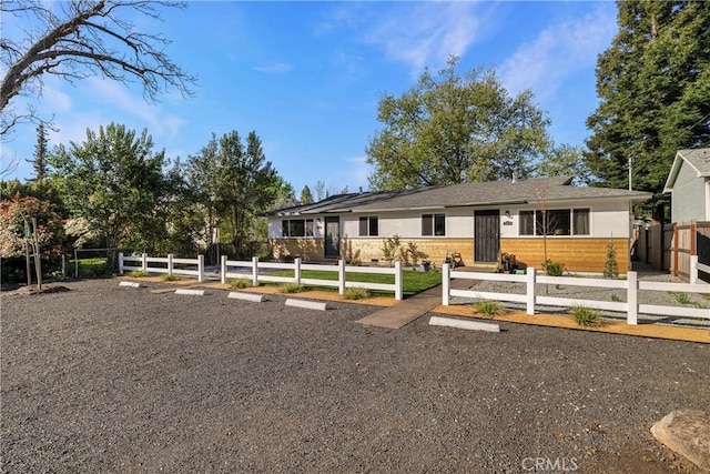 view of front of home featuring fence and stucco siding