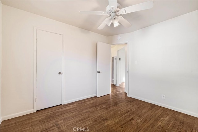 unfurnished bedroom featuring ceiling fan, baseboards, and wood finished floors