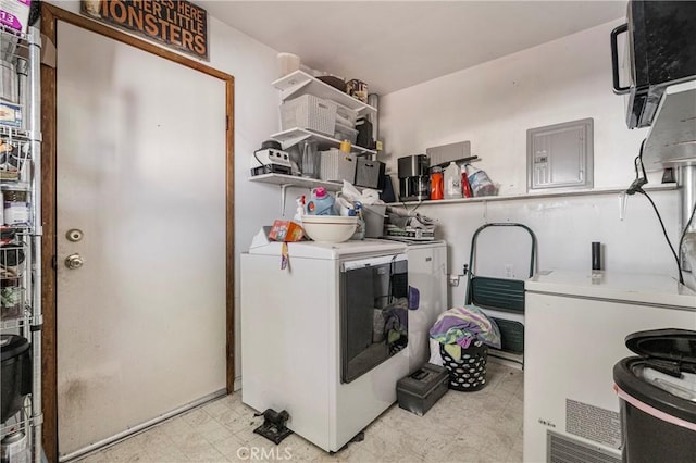 laundry area with light floors, washing machine and dryer, electric panel, and laundry area