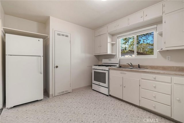 kitchen featuring a sink, light floors, white cabinetry, white appliances, and open shelves
