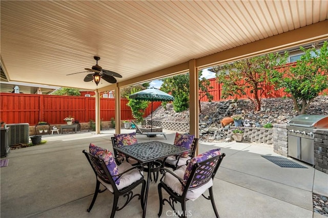 view of patio / terrace with area for grilling, outdoor dining area, an outdoor kitchen, a ceiling fan, and a fenced backyard