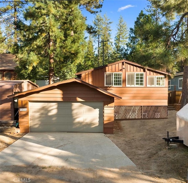 view of front of house featuring concrete driveway, board and batten siding, and a garage