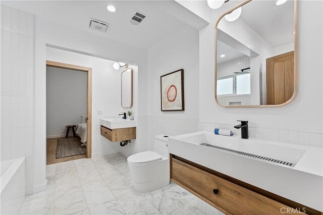 full bathroom with visible vents, marble finish floor, toilet, and a sink