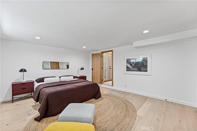 bedroom with recessed lighting, light wood-style flooring, and baseboards