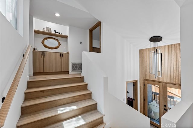 stairs with visible vents and recessed lighting