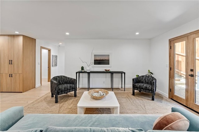 living area featuring french doors, recessed lighting, and light wood-style flooring