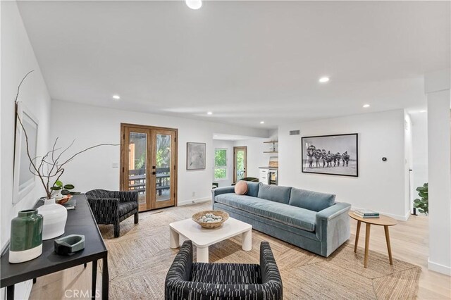 living area with visible vents, french doors, baseboards, and recessed lighting