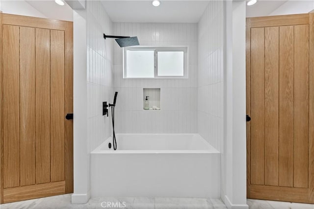 bathroom featuring recessed lighting and bathing tub / shower combination