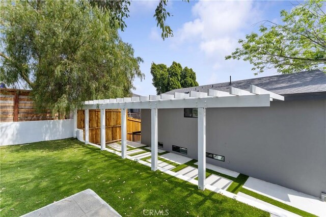 back of house with fence and a yard