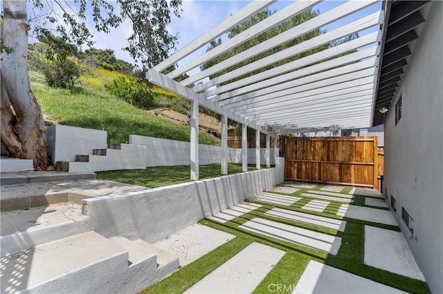 view of yard with a pergola and fence