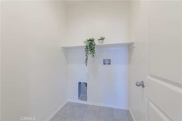 laundry room featuring light tile patterned floors, baseboards, laundry area, and hookup for a washing machine