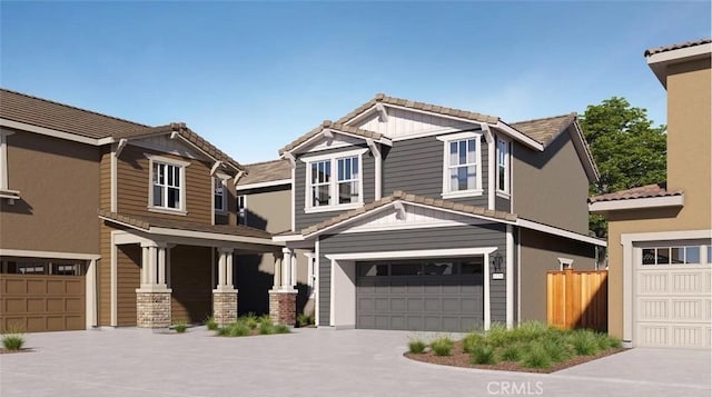 craftsman-style home with an attached garage and a tile roof