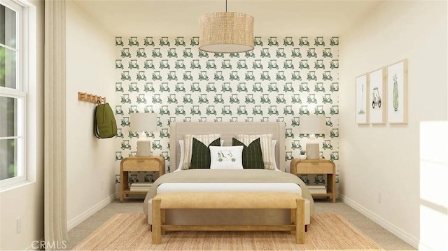 bedroom featuring baseboards and light carpet