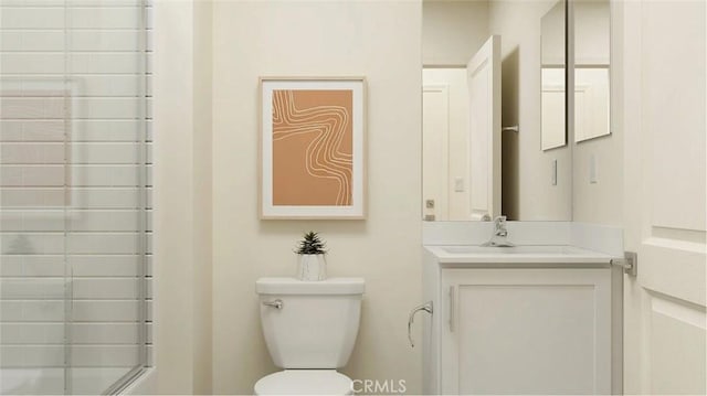 bathroom with vanity, toilet, and a shower with door