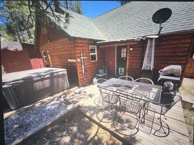 view of patio / terrace featuring outdoor dining area and a hot tub