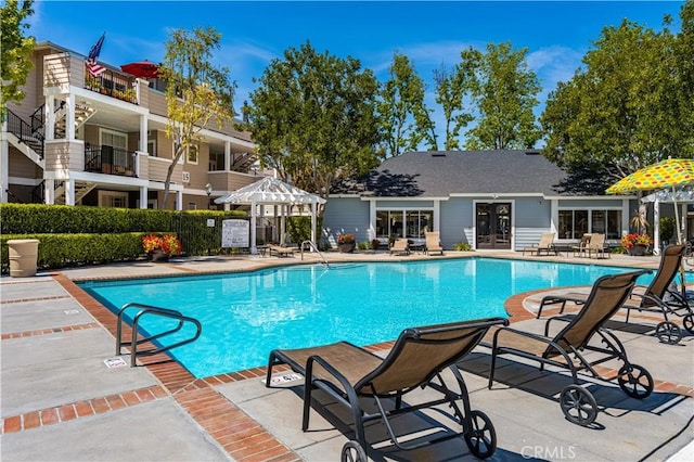 pool with a patio and french doors