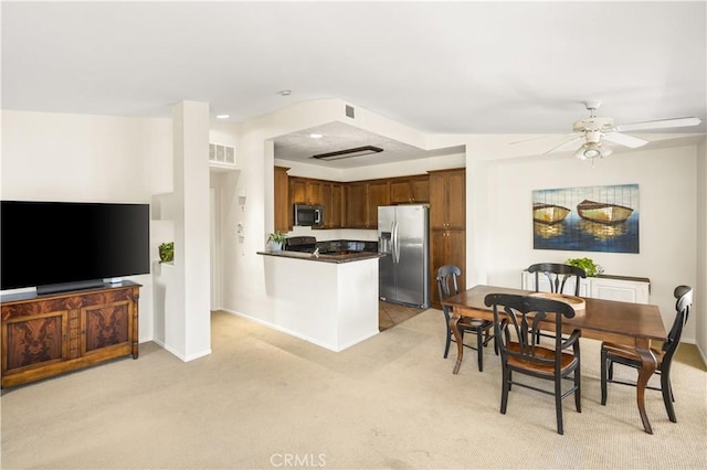 dining space with light carpet, baseboards, a ceiling fan, and visible vents