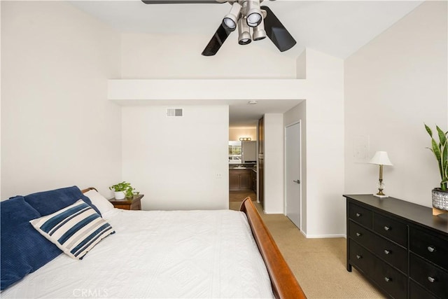 bedroom featuring baseboards, visible vents, light carpet, and ceiling fan