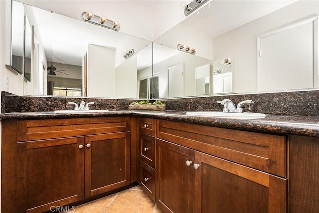 bathroom with ceiling fan, a sink, and double vanity
