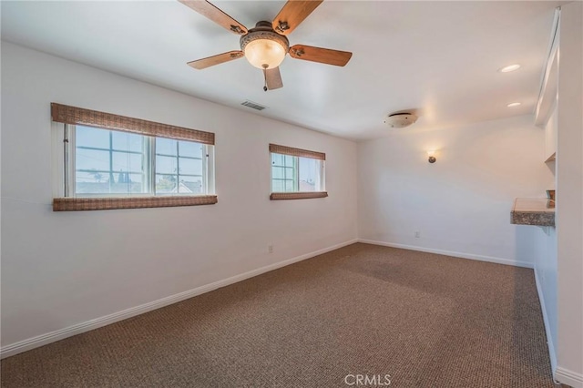 carpeted spare room with recessed lighting, a ceiling fan, visible vents, and baseboards