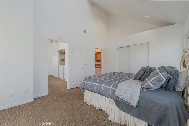 bedroom with separate washer and dryer, carpet flooring, baseboards, visible vents, and high vaulted ceiling