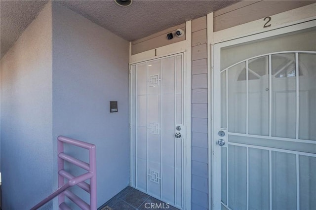 entrance to property with stucco siding