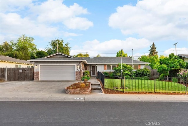 single story home with a front lawn, a fenced front yard, concrete driveway, a garage, and brick siding