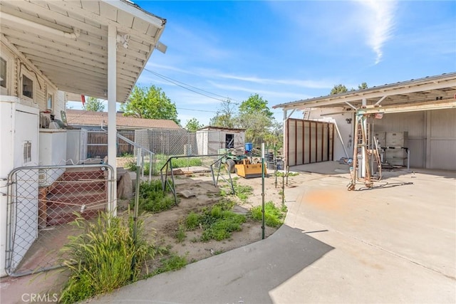 270 San Jacinto St, San Jacinto, CA 92544 - view of yard with an outdoor structure, a shed, a patio, and fence