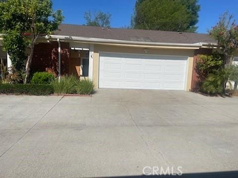 garage with concrete driveway