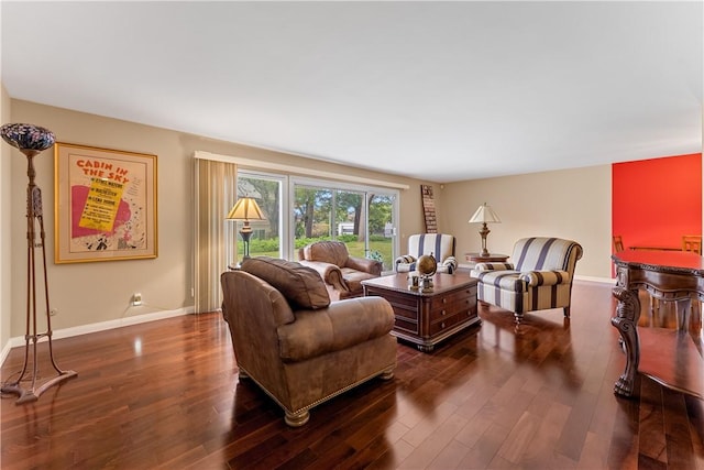 living area with baseboards and dark wood finished floors