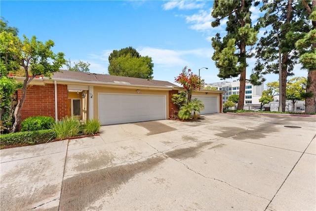 ranch-style house with stucco siding and fence