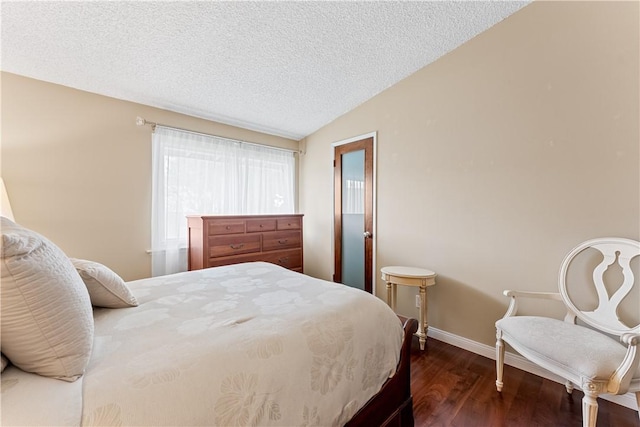 bedroom featuring dark wood-style flooring, baseboards, vaulted ceiling, and a textured ceiling