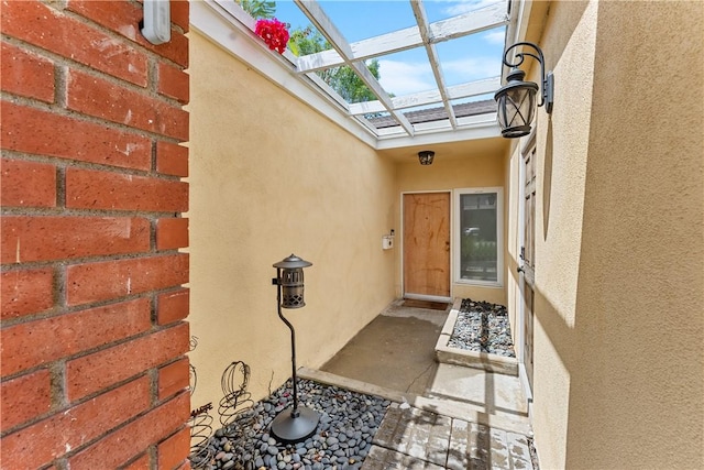 view of exterior entry with stucco siding