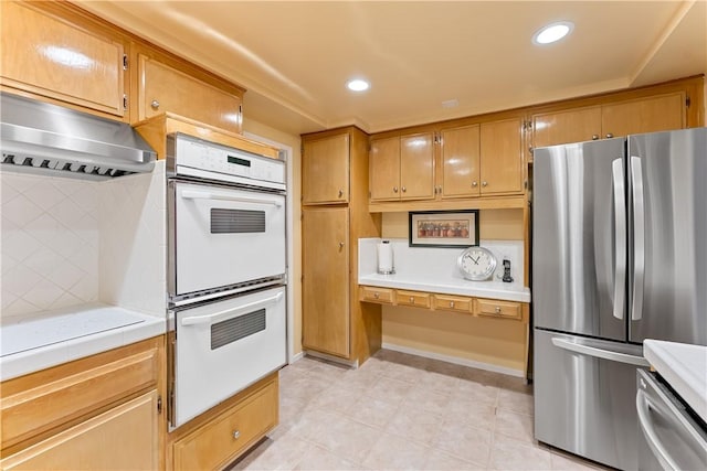 kitchen featuring under cabinet range hood, recessed lighting, tile countertops, and appliances with stainless steel finishes