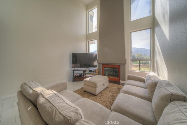 10917 Breezy Meadow Dr, Moreno Valley, CA 92557 - living area with a towering ceiling, baseboards, marble finish floor, and a wealth of natural light