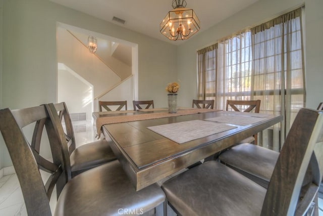 10917 Breezy Meadow Dr, Moreno Valley, CA 92557 - dining area with a chandelier and visible vents