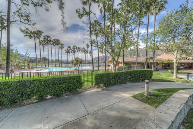 10917 Breezy Meadow Dr, Moreno Valley, CA 92557 - view of community with fence and a swimming pool