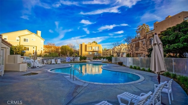pool featuring a residential view, fence, and a patio area