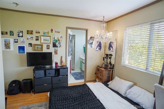 bedroom with a chandelier, wood finished floors, and ornamental molding